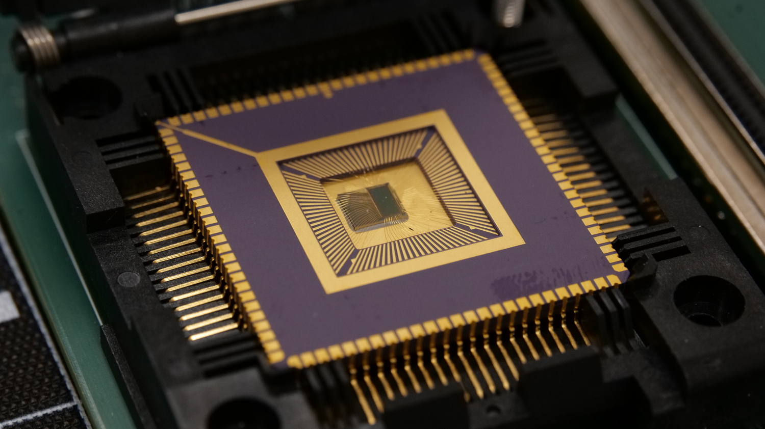Picture of a small gold and purple computer processor chip